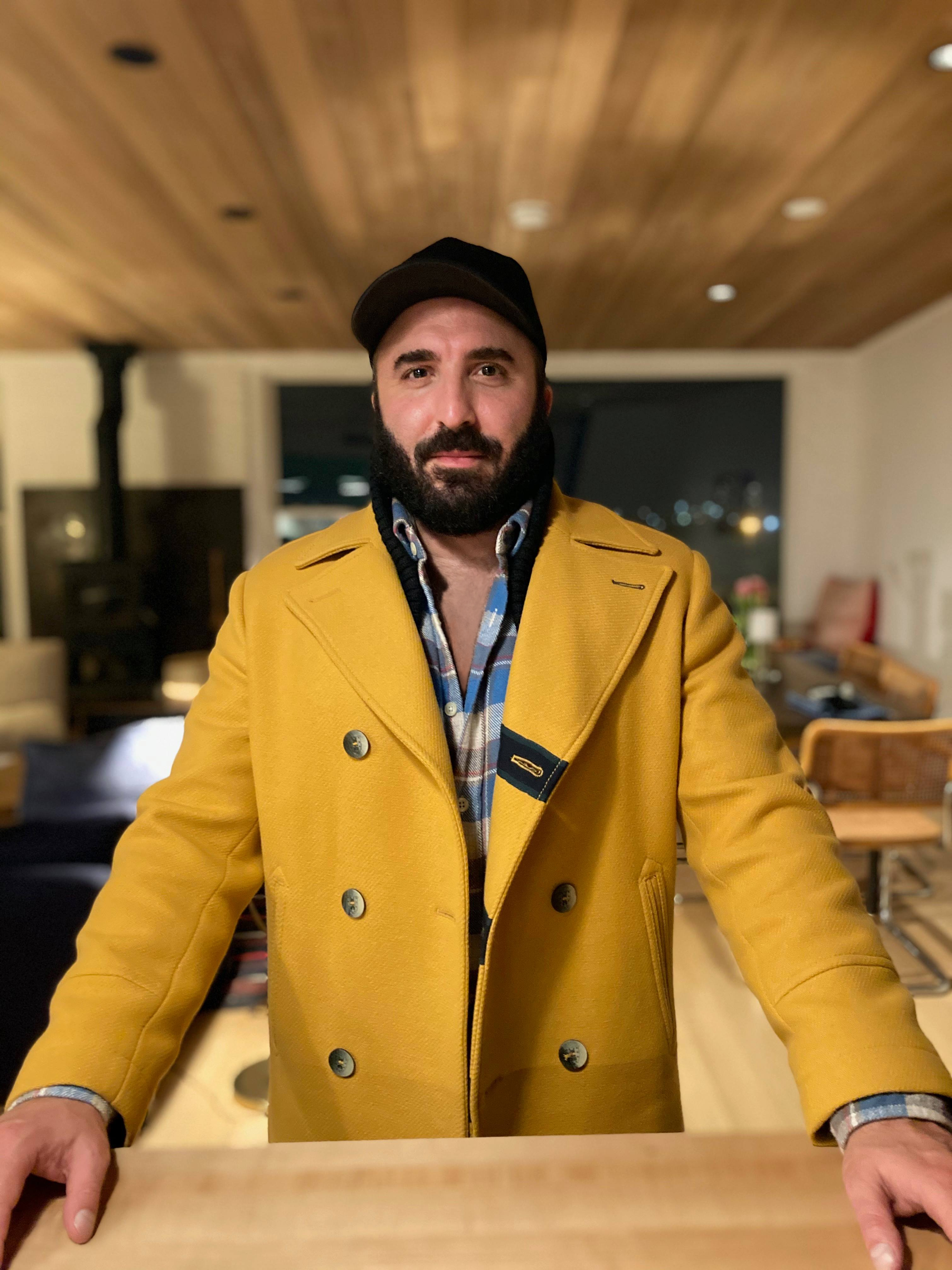 Photograph of Chris wearing a yellow coat.